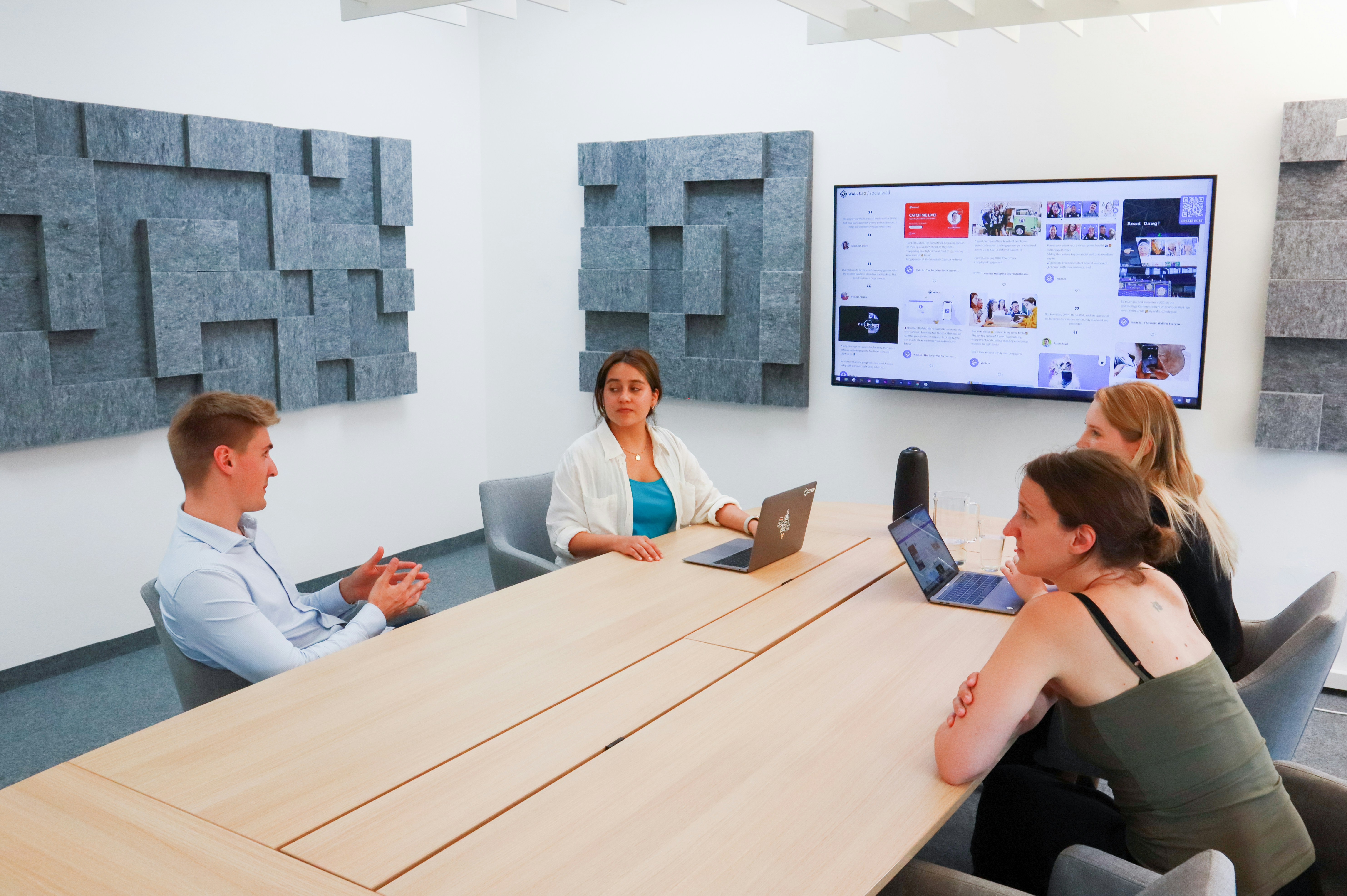 Team of professionals collaborating around a conference table in a modern meeting room